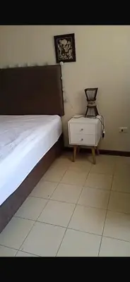 a bedroom with a bed and a chair in it at Confort Maruja in Lima