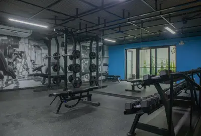 a gym with lots of equipment and a blue wall at Art by Wynwood House in Lima