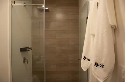a bathroom with a shower with a glass door at Art by Wynwood House in Lima
