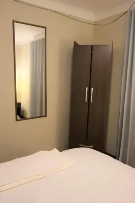a bedroom with a bed and a mirror at Casa Canal - 3 cuadras de la Plaza de Armas in Cusco