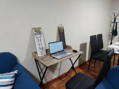a table with a laptop computer on top of it at JTM Apartament in Cusco