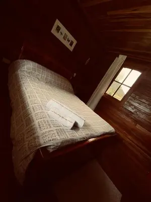 a bed in a room with a window at Yoly cabaña in San Francisco