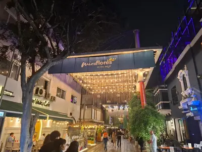 a group of people walking on a street at night at Departamento en el Corazón de Miraflores Peru in Lima