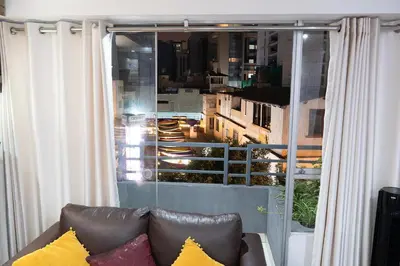 a couch sitting in front of a window with a view at Departamento en el Corazón de Miraflores Peru in Lima