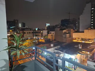 a view of a city at night from a balcony at Departamento en el Corazón de Miraflores Peru in Lima