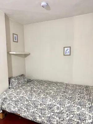a small bedroom with a bed in a room at Florencia Lodgement in Lima