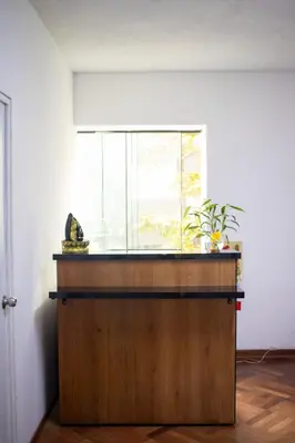 a kitchen with a counter with a window in a room at Gutierrez Hostel in Lima