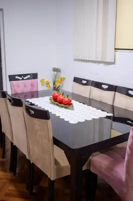 a dining room table with chairs and a bowl of tomatoes on it at Gutierrez Hostel in Lima
