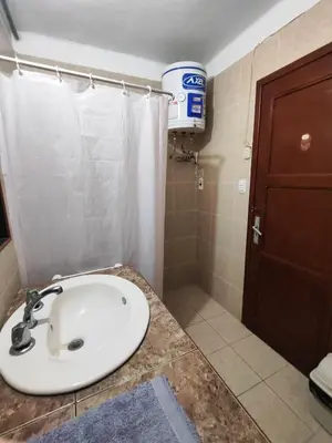 a bathroom with a sink and a shower at Céntrica habitación con vistas Miraflores in Lima