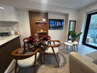 a kitchen and living room with a table and chairs at Brand new apartment in Miraflores in Lima