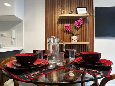 a table with red plates and bowls on top of it at Brand new apartment in Miraflores in Lima