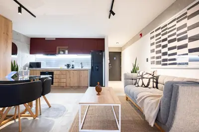 a living room and kitchen with a couch and a table at Barranco Breeze Loft Apartments by Geko in Lima