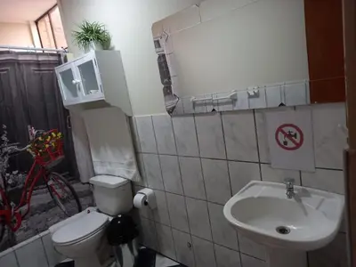 a small bathroom with a toilet and a sink at Angelica's House - Apartments Lima - Near the Airport in Lima