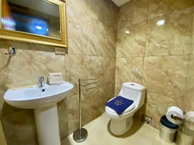 a bathroom with a sink and a toilet at Hotel Panaka II in Cusco