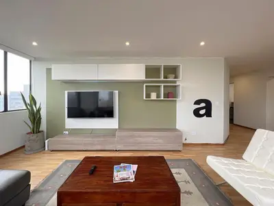 a living room with a couch and a tv at Sky Flatt 2BR by Geko in Lima