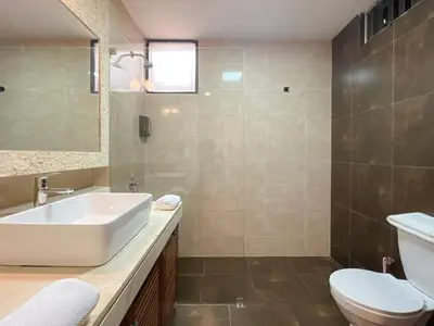 a bathroom with a white sink and a toilet at Sky Flatt 2BR by Geko in Lima