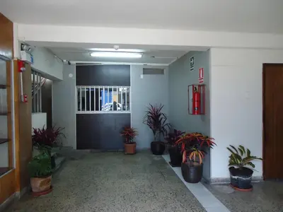 an empty hallway with potted plants in a building at Hotel Estación Central in Lima