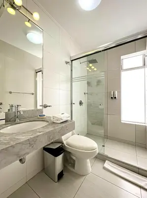 a bathroom with a toilet and a sink and a shower at The Snake 1BR by Geko in Lima