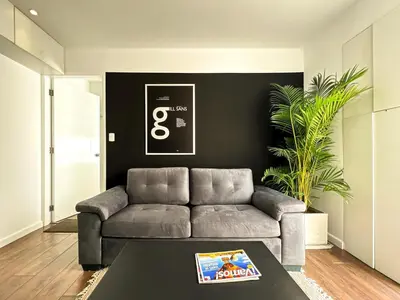 a living room with a couch and a table at The Snake 1BR by Geko in Lima