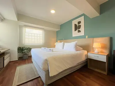a bedroom with a large white bed and a window at Coco 3BR by Geko in Lima