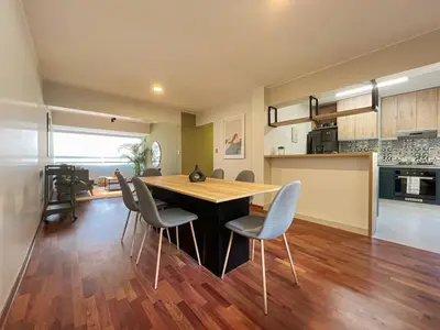 a kitchen and dining room with a table and chairs at Coco 3BR by Geko in Lima