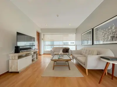 a living room with a couch and a table at Barranco Sailor Apartment by Geko in Lima