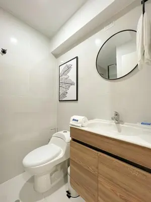 a bathroom with a toilet and a sink and a mirror at The Bird 2BR by Geko in Lima