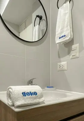 a bathroom with a tub with a mirror and towels at The Bird 2BR by Geko in Lima