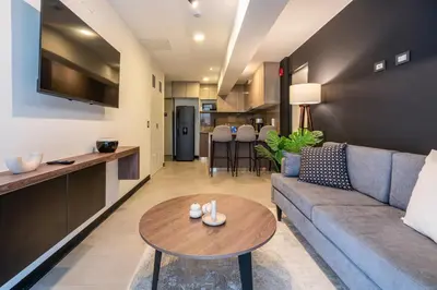 a living room with a couch and a table at Rivera Navarrete by Geko in Lima