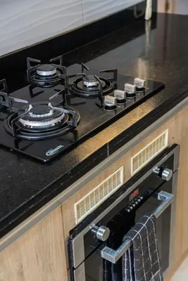a stove top oven sitting on top of a kitchen counter at Caoba 3BR by Geko in Lima