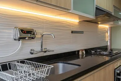 a kitchen sink with a dish drying rack and a sink at Caoba 3BR by Geko in Lima