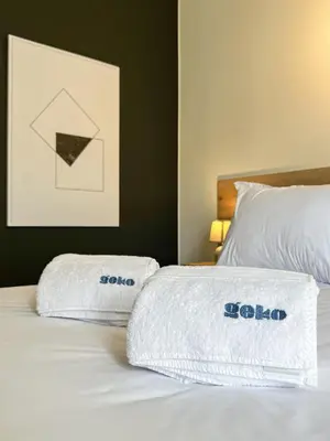 a bed with two towels on top of it at Syberia 2BR by Geko in Lima