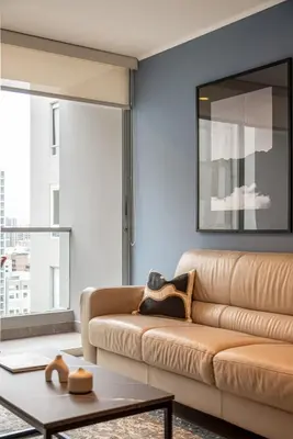 a living room with a couch and a table at Midnight District Apartment by Geko in Lima