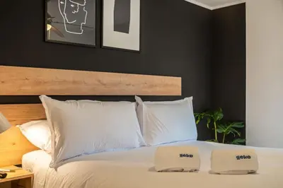 a bedroom with a white bed with two white pillows at Midnight District Apartment by Geko in Lima