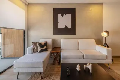 a living room with a white couch and a table at Sahara Sunset 2BR by Geko in Lima