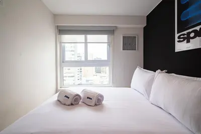 a bedroom with two pillows on a bed with a window at Taurus 2BR by Geko in Lima