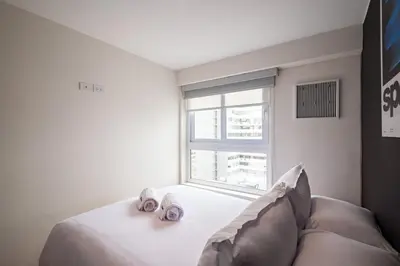 a bedroom with a bed with two towels on it at Taurus 2BR by Geko in Lima