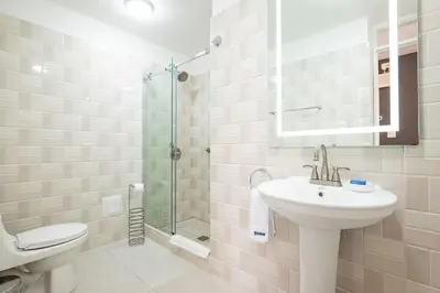 a bathroom with a sink and a toilet and a shower at The Kennedy 3BR by Geko in Lima