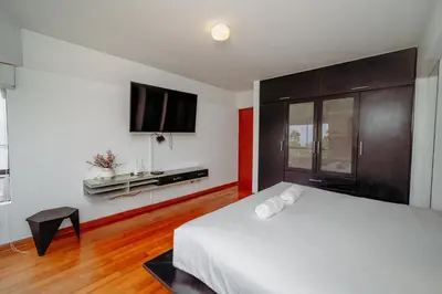 a bedroom with a bed and a flat screen tv at Manuel Tovar Apartment in Miraflores 1 BDR in Lima
