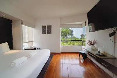 a bedroom with a white bed and a large window at Manuel Tovar Apartment in Miraflores 1 BDR in Lima