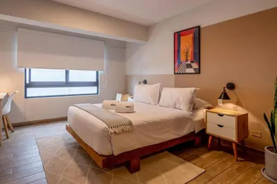a bedroom with a large bed and a window at Wonderland 2BR by Geko in Lima