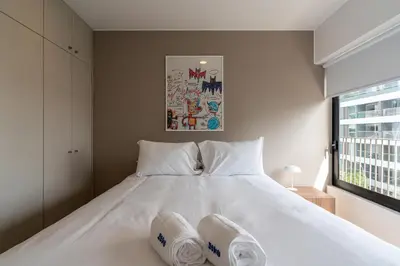 a bedroom with a white bed with two pillows on it at Francia by Geko in Lima