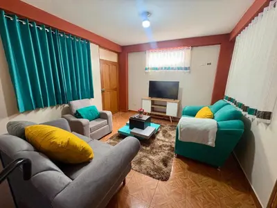a living room with two couches and a television at Nido Cusqueño in Cusco