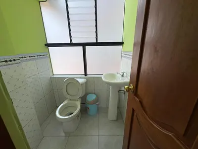 a small bathroom with a toilet and a sink at Nido Cusqueño in Cusco