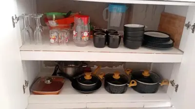 a shelf filled with pots and pans and plates at Casa Sunampe Chincha - 2do Piso in Sunampe