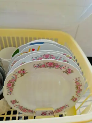 a stack of plates sitting in a dish rack at Departamento con baño privado in Ayacucho