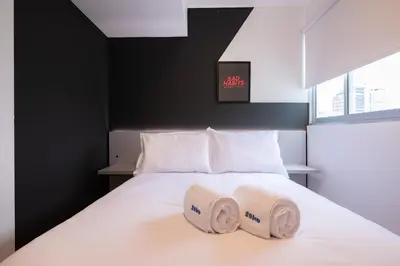 a bedroom with a bed with two towels on it at Grimaldo by Geko in Lima