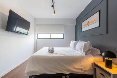 a bedroom with a bed with a teddy bear on it at Dubrovnik 2BR by Geko in Lima