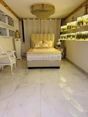 a bedroom with a king sized bed and a chandelier at El Palacio del Rey in Lima