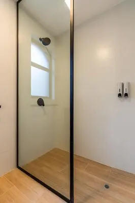 a glass door in a room with a window at Vince City 1BR by Geko in Lima